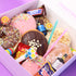 Assorted donuts and candies in a box with visible brand names.
