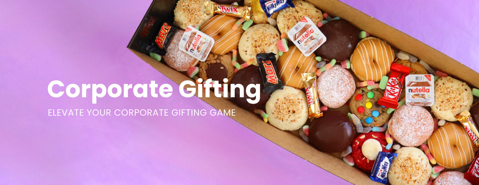 Box of assorted candies and snacks with 'Corporate Gifting' text on a purple background