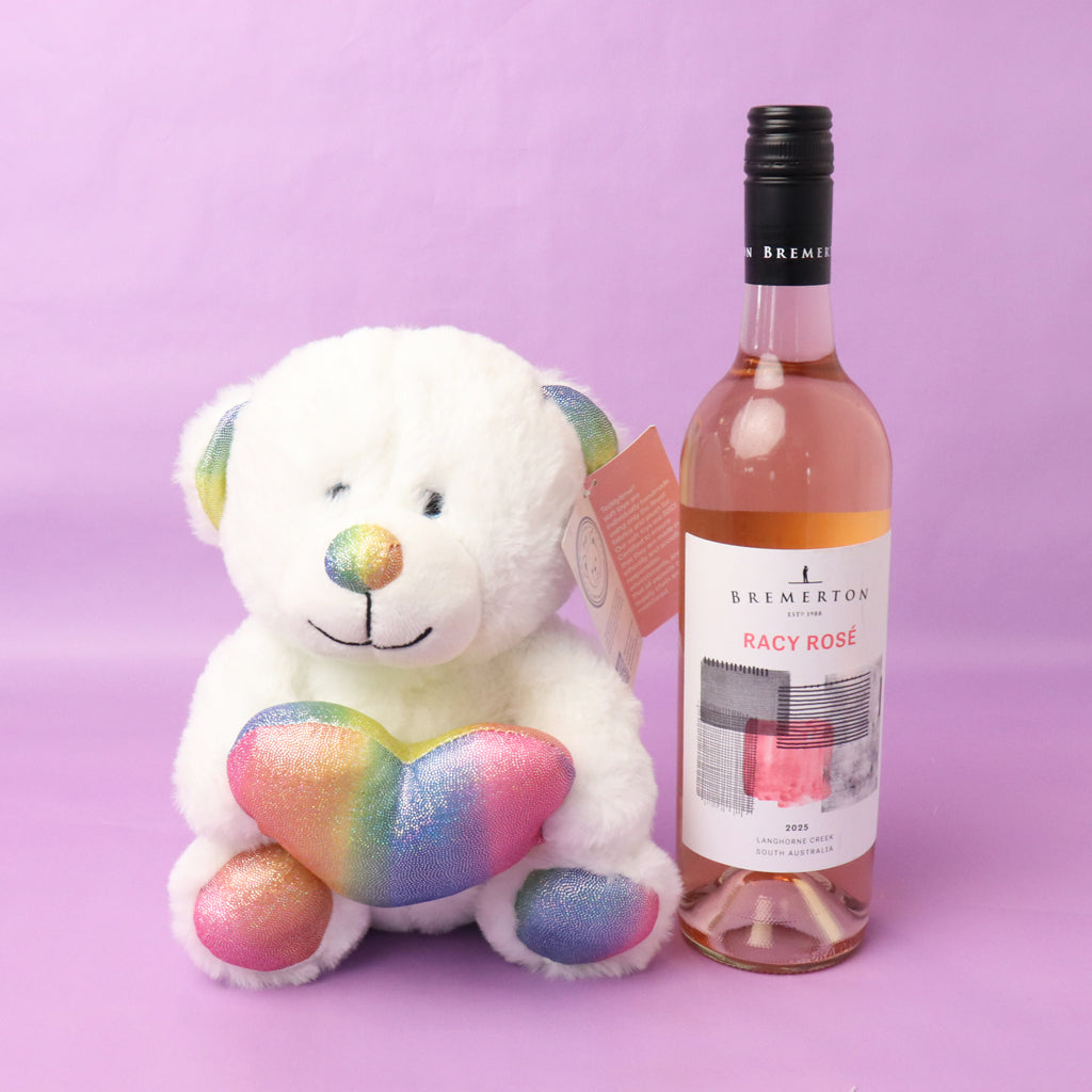 Bottle of Bremerton Racy Rosé wine with a plush teddy bear on a purple background