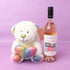 Bottle of Bremerton Racy Rosé wine with a plush teddy bear on a purple background