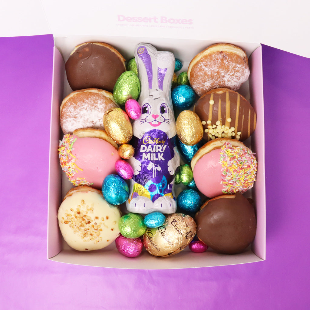 Assorted donuts and Cadbury Dairy Milk Easter eggs in a gift box