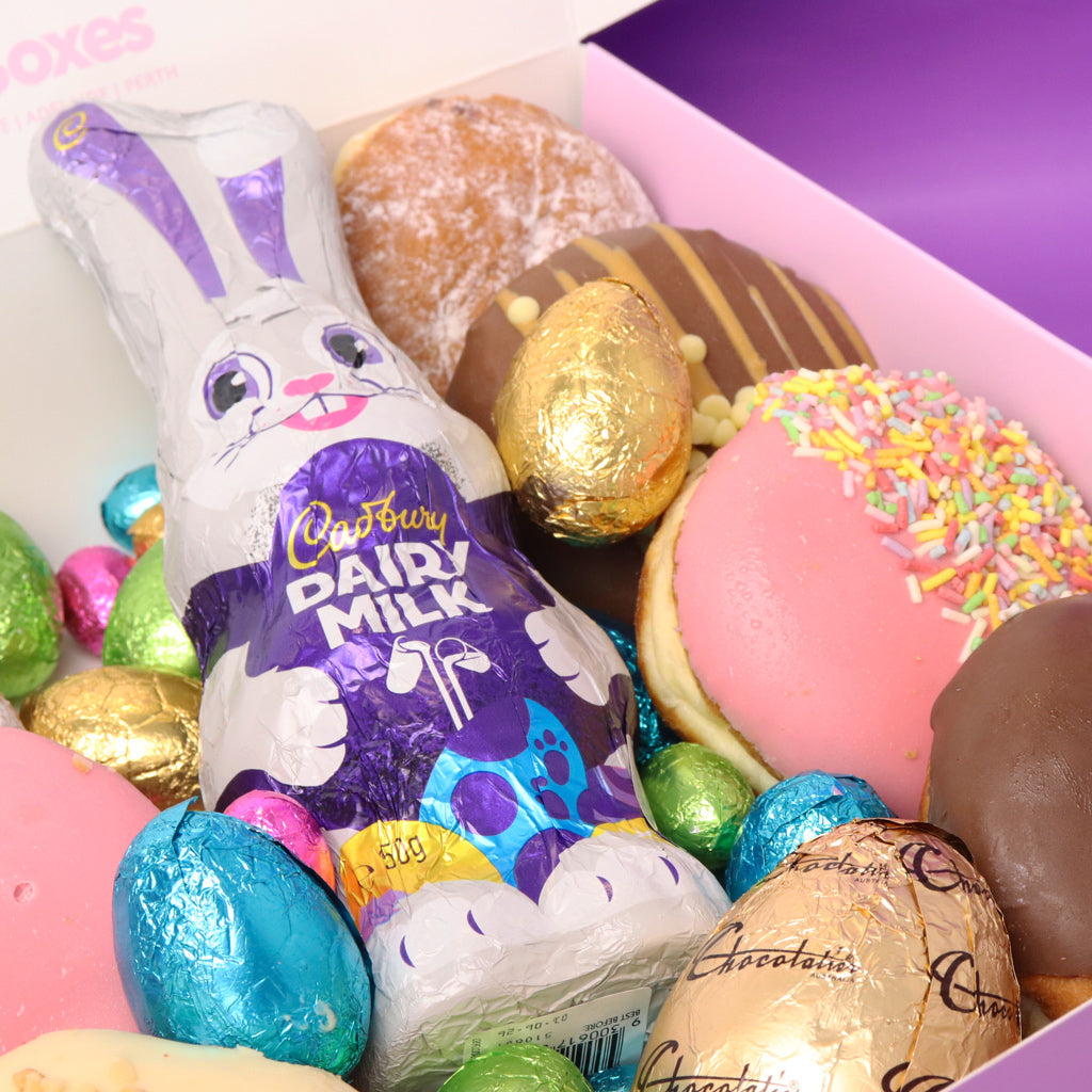 Cadbury Dairy Milk Easter bunny chocolate bar among Easter eggs and donuts