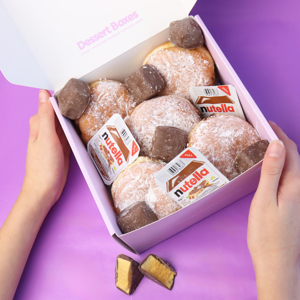 Box of donuts with Nutella spread on a purple background