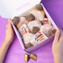 Box of donuts with Nutella spread on a purple background