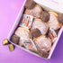 Box of donuts with Nutella filling on a purple background