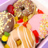 Colorful donuts with various toppings in a box