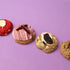 Assorted cookies with different flavors on a purple background